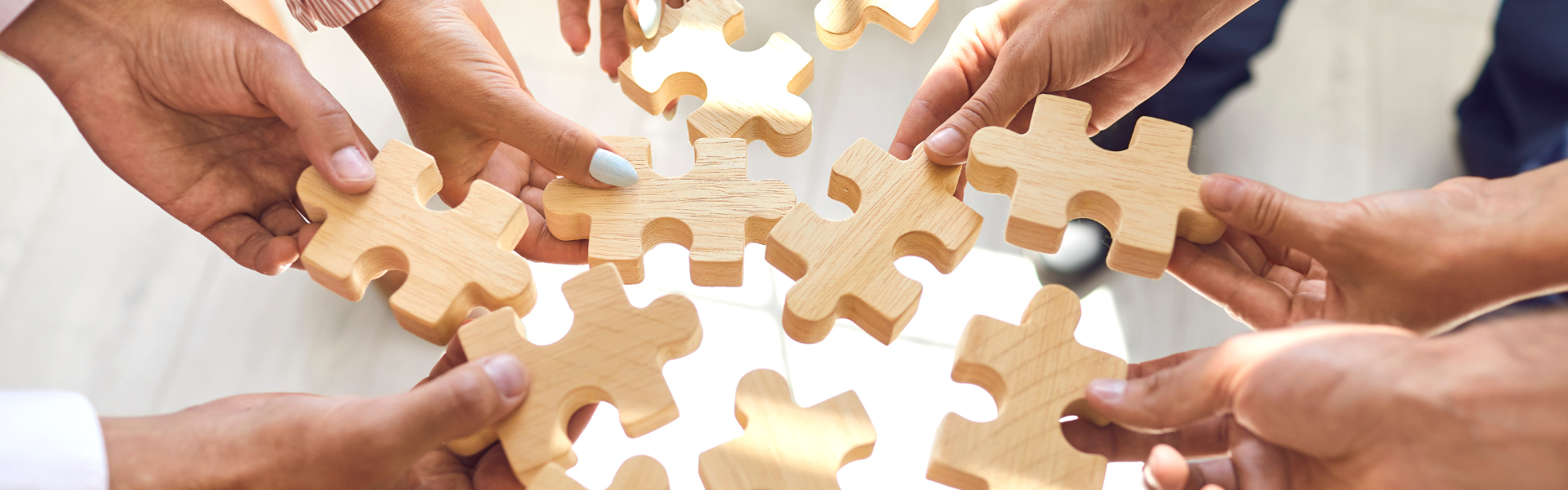 Hands holding puzzle pieces